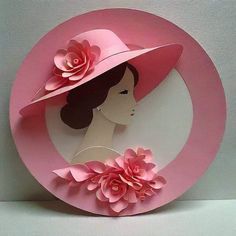 a paper plate with a woman wearing a pink hat and flowers on it