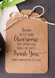 a brown paper tag with the words thank you stamp on it