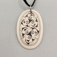 Celtic Art by Touchstone Pottery * Handmade from fine porcelain * Features Nehalennia protector of travelers design * Black ribbon necklace * Comes in a jewelry box with an informational sheet Features: * Celtic * Bisque * Made in Canada Size: Unisex 1.5" x 1" Condition: New With Box No damage. Artisan Carved Black Necklace, Elegant Black Enamel Medallion Necklace, Black Carved Symbolic Necklace, Porcelain Necklace Ceramics, Porcelain Necklace, Ribbon Necklace, Pottery Handmade, Celtic Art, Black Ribbon