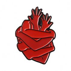 a red heart with hands on it is sitting in front of a white background,