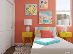 a bedroom with pink walls, yellow nightstands and pictures on the wall above the bed