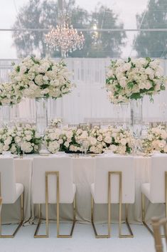 there are many vases with flowers on the table