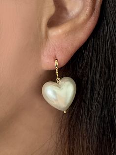 Large Heart acrylic Pearl Earrings, Heart dangling earrings, Bridal Jewelry, Gift for her, Imitation Pearl, Gold Huggies, Heart earrings This Cute Puffy imitation(fake/acrylic) pearl dangling from a small gold hoop earrings is very charming. Great piece for a wedding party or daily wear. * Total Heart pearl Hoop drop earrings measures approx. 30mm * Imitation Acrylic Heart Pearl measures approx. 17.2mm x 19mm and 11.5mm Thick ** Matching Earrings ** https://www.etsy.com/listing/1521279859/large-heart-acrylic-pearl-necklace-gold?click_key=fac6d962d950cf3f37620a1fb31158dd2cefefdb%3A1521279859&click_sum=083acbe9&ref=shop_home_active_7 ---------------------------------------------------------------------- ** F E A T U R E S ** - Imitation Acrylic Heart Pearl - Gold Brass Hoop earrings -------- Wedding Heart Beads Drop Earrings, Heart Charm Pearl Earrings As A Gift, Wedding Heart Beads Dangle Earrings, Heart Pearl Earrings, Single Heart Earring For Wedding, Wedding Heart Earrings With Pearl Drop, Valentine's Day Pearl Drop Earrings For Party, Heart Shaped Pearl Drop Jewelry For Parties, White Heart Charm Earrings For Party