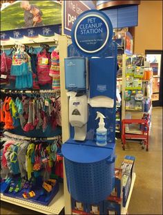 a display in a children's store with clothes hanging on the rack and other items for sale