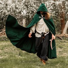 Green Cloak w/ Wolf Clasp - Heavy Wool Hooded Cape with Buckle For men or women. Heavy wool cape with a short hood and a wolf styled clasp. Material: 72% wool, 16% polyester 6% nylon, 4% cotton, 2% viscose.Available Colors: Green. Approx. Length: 51" (131cm).Approx. Width: 91" (231cm) in width. Worldwide shipping available!Custom made to order: Please allow up to 1-3 weeks before item ships. Share: Hooded Outerwear For Fantasy Events In Winter, Hooded Winter Cape For Fantasy Events, Hooded Cape For Fantasy Events In Winter, Elvish Hooded Costume Outerwear, Green Cloak, Hooded Cape, Wool Cape, A Wolf, Colors Green