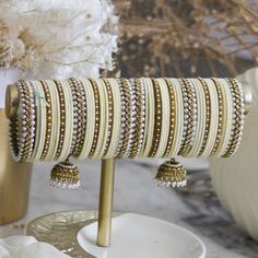 This stylish bangle set is crafted with love and care by the finest artisans, and is the perfect accessory for your destination Indian wedding. Its white colour complements any colour palette, bringing a unique and chic flair to your nuptials. Make your special day even more memorable with this handcrafted bangle set. Bollywood Style White Bridal Sets With Latkans, White Bollywood Bangle For Wedding, White Wedding Bangle For Festive Occasions, Bollywood Style White Wedding Bangle, White Bollywood Style Wedding Bangle, White Wedding Bangle For Festive Season, Traditional White Bridal Sets For Wedding, Festive White Wedding Bangle, Festive White Bridal Sets For Weddings