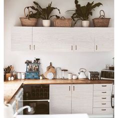 the kitchen counter is clean and ready to be used as a coffee bar or potted plant