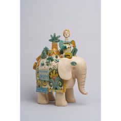 an elephant figurine with a woman riding on it's back