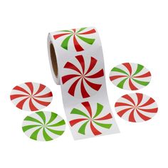 a roll of christmas candy canes with green and red stickers on it's side