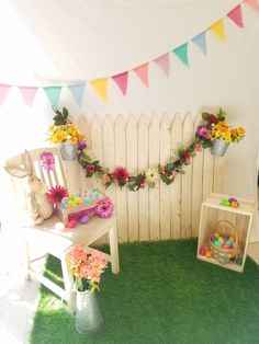 a room decorated with flowers and bunting for an easter egg decorating contest on the lawn