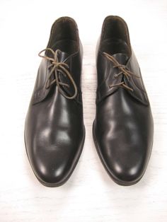 "Oviatt's original vintage men's black leather semi-round plain toe derby shoes. Made in England circa 1960s. The Oviatt model. Semi-round plain toe. Leather insoles. Leather outsoles with nailed heel. Great pre-owned condition with some slight wear around the opening with some missing stitching around the edge and also the cobblers nails protrude up into the heel area of the insole so I would suggest having the insert removed and a heel pad added (see all pics at bottom of description). It's ha Vintage Black Oxford Lace-up Shoes, Retro Black Oxfords For Derby, Vintage Leather Lace-up Shoes With Plain Toe, Masculine Round Toe Dress Shoes For Derby, Vintage Almond Toe Lace-up Work Shoes, Vintage Oxfords With Leather Footbed For Work, Vintage Black Oxfords With Leather Footbed, Vintage Leather Oxford Shoes For Work, Vintage Leather Oxfords For Work