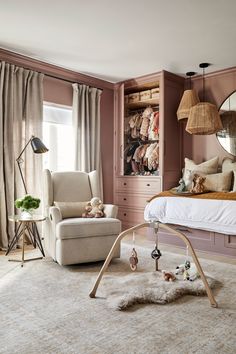 a bedroom with pink walls and furniture