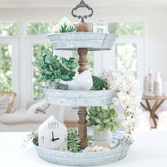 three tiered trays with plants and other decorations