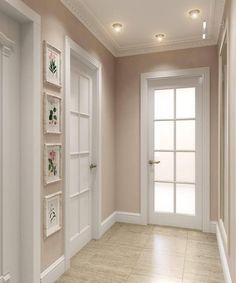 an empty room with white doors and beige walls