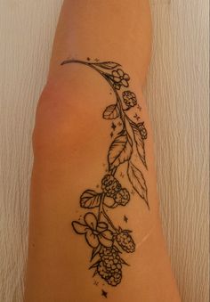 a woman's arm with flowers and leaves on the left side of her body