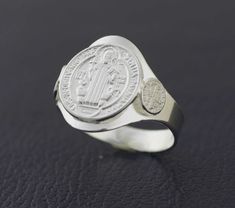 This Beautiful and Traditional Saint Benedict is made from high-quality Sterling Silver 925 Its the perfect gift for anyone of any age and excellent for everyday wear. Item Specifications: Model # PAS2 Metal Type: Sterling Silver Metal Stamp: 925 Shape St. Benedict Style: Traditional Ring Front : 14mm (9/16 inch) Size: 6, 7, 8, 9, 10 Stones: No All jewelry comes in a gift box We will ship within 1-2 business days by USPS, Please make sure your address is correct As we mention customer service is Adjustable Silver Rings For Commemoration, Silver Sterling Engraved Ring For Commemoration, Classic Sterling Silver Signet Ring For Commemoration, Classic Sterling Silver Rings For Commemoration, Classic White Gold Rings For Commemoration, Silver Engraved Ring Stamped 925 For Commemoration, Commemorative White Gold Sterling Silver Signet Ring, Commemorative Sterling Silver Rings, Classic Silver Signet Ring For Commemoration