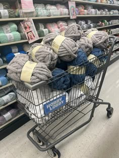 a shopping cart filled with yarn in a store