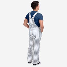 Show your team spirit in these stylish and comfortable New York Yankees Men's Pinstripe Bib Overalls. With their all-over team-colored design and bold team logo display, these overalls are the perfect way to show your support for the New York Yankees while showing off some pinstriped style that will go great with your team jersey and the rest of your team gear. The bib pocket is perfect for storing your phone, wallet, or other essentials, and the adjustable bib shoulder straps ensure a comfortab Striped Cotton Overalls, Logo Display, Team Gear, Bib Overalls, Team Jersey, New York Mets, Major League Baseball, Phone Wallet, New York Yankees