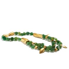 18K, 22K & 24K yellow gold, unpolished tsavorite garnet beads A single strand of natural green garnet beads makes its way to a double strand as the branches of gold bring new growth and seeds of change to the front of this exquisite necklace. • 16.5" (41.9cm) length • 1.75" (4.44cm) width in front • One of a kind Elegant Gold Emerald Necklace With Faceted Beads, Elegant Gold Hand-strung Emerald Necklace, Elegant Hand-strung Gold Emerald Necklace, Hand-strung Gold Emerald Necklace Gift, Nature-inspired Gold Jewelry With Gemstone Beads, Gold Double Strand Hand-strung Necklace, Nature-inspired Gold Jewelry With Round Beads, Seeds Of Change, Tsavorite Garnet