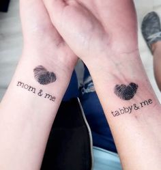 two people with matching tattoos on their arms