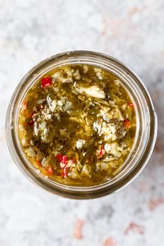 a glass jar filled with food sitting on top of a table