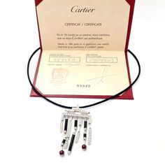 Metal: 18k White Gold  Measurements: Length silk cord: 17.25''  Pendant: 33mm x 62mm  Weight: 24.5 grams  Stones: 153 round brilliant diamonds, E color, VVS1 clarity total weigh approximately 3ct. Also with 6 onyx stones, and 2 ruby beads 6mm each.  Hallmarks: Cartier 750 (serial number omitted) French Hallmarks   Please read description for most accurate dimensions and use QA to inquire on any additional details. Cartier Black Evening Jewelry, Luxury Cartier Jewelry For Evening, Designer Black Necklace As A Gift, Designer Black Necklace For Gift, Designer Black Necklaces For Gift, Ruby Diamond Necklace, Vintage Designer Jewelry, Ruby Beads, Silk Cord