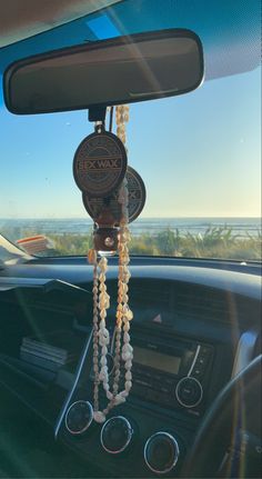 a car dashboard with beads hanging from the dash