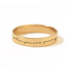 Have your favorite Taylor Swift quote engraved on a classic band ring. Gold Filled Hypoallergenic, lead and nickel free Band Width 3.5mm Customize your message, maximum of 60 characters (including spaces). In photo: "Life is tough my darling, but so are you" - Maya Angelou #R015-G Meaningful Engraved Promise Ring With Engraving Option, Meaningful Promise Ring With Engraving Option, Minimalist Engraved Ring For Promise, Adjustable Engraved Ring With Text For Promise, Meaningful Engraved Ring For Promise, Classic Promise Ring With Engraved Text, Adjustable Engraved Ring With Round Band, Taylor Swift Quote, Engraved Ring