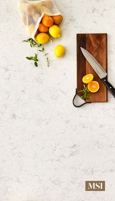 a cutting board topped with sliced oranges next to a knife on top of a counter