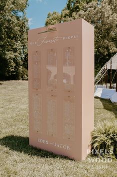 a large sign sitting in the middle of a grass covered field