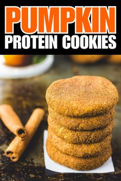 pumpkin protein cookies stacked on top of each other with cinnamon sticks in the foreground