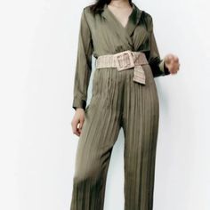 Creased Jumpsuit With A Lapel Collar V-Neckline And Long Sleeves Contrast Belt And Elastic Waistband. Straight-Leg Design. New With Tag Color : Olive Green Solid Belted Jumpsuit For Date Night, Green V-neck Jumpsuit For Work, Belted Jumpsuits And Rompers For Date Night, Belted Jumpsuit For Date Night, Belted Jumpsuit Or Romper For Date Night, Elegant V-neck Jumpsuits And Rompers For Spring, Chic Green Long Sleeve Jumpsuits And Rompers, Chic High-waist Jumpsuits And Rompers For Fall, Chic Summer Pantsuit With Long Sleeves