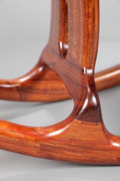 a close up of a wooden chair on a white surface