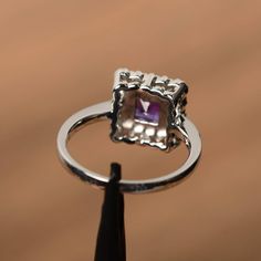 It is a natural amethyst ring, princess cut, measures 5mm*5mm, weight about 0.7 cts. The basic metal is sterling silver and plated with rhodium. To change the metal to a solid gold (white/rose) or platinum is also available, please ask for a quotation if you want. You can also go to my shop Home for more elegant rings: https://www.etsy.com/shop/godjewelry?ref=hdr_shop_menu amethyst is birthstone of February More amethyst rings: https://www.etsy.com/shop/godjewelry?ref=seller-platform-mcnav&s Princess Cut Jewelry With Accent Stones, 14k White Gold Princess Cut Jewelry With Halo Setting, 14k White Gold Princess Cut Halo Jewelry, Princess Cut 14k White Gold Jewelry With Halo Setting, Princess Cut Halo Jewelry In 14k White Gold, Silver Sapphire Solitaire Ring Princess Cut, Fine Jewelry Princess Cut Birthstone Diamond Ring, Fine Jewelry Princess Cut Diamond Birthstone Ring, Fine Jewelry Diamond Ring With Princess Cut Birthstone