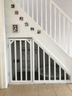 an open door leading to a bed in a room with white stairs and pictures on the wall