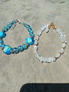 1 white cats eye and crystal bracelet with gold tone findings  1 shades of blue beachy summertime bracelet.   Made with blue glass and blue with little bit of yellow beads. Silver spacers beads. Crystal bead bracelet, bridal jewelry, bridal bracelet, beach and tropical,gift for her Can be purchased separately. Price is $15 per bracelet Beaded Bracelets Blue, Summer Beaded Bracelets, Blue Crystal Bracelet, Glass Bead Bracelet, Adjustable Jewelry, Crystal Beads Bracelet, Jewelry Crystal, Wedding Jewelry Bracelets, Cats Eye