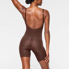 A sculpting bodysuit that sculpts silhouette, cinches waist, and smooth thighs while providing support and lift for your curves. Featuring a deep scoop back that makes it the perfect backless shapewear option. | SKIMS Low Back Mid Thigh Bodysuit | Deep Neutral | XS | Seamless Sculpt Backless Shapewear, Sculpting Bodysuit, Women's Shapewear, Body Shapers, Cinched Waist, Low Back, Kim Kardashian, Shapewear, Cocoa