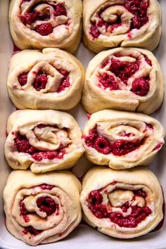 raspberry pinwheels in a baking dish, ready to be baked into the oven