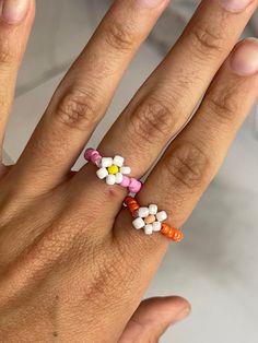 Elastic seed bead ring with a beaded flower Summer Beaded Flower-shaped Jewelry, Summer Flower-shaped Beaded Jewelry, Dainty Beaded Flower Jewelry, Flower-shaped Jewelry With Tiny Beads For Spring, Dainty Flower-shaped Beaded Jewelry, Adjustable Beaded Rings For Summer, Handmade White Flower Ring For Spring, Colorful Beads Flower Ring Gift, Adjustable Multicolor Flower Ring With Colorful Beads