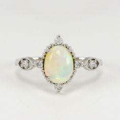 Oval White Gold Birthstone Ring For Wedding, Vintage Opal Wedding Ring Birthstone, Vintage Opal Wedding Ring As Birthstone, Heirloom Wedding Diamond Ring With Birthstone, Vintage Diamond Opal Ring For Anniversary, Oval Birthstone Ring With Diamond Accents For Wedding, Vintage Sterling Silver Opal Wedding Ring, Vintage Sterling Silver Opal Ring For Wedding, Classic Opal Birthstone Ring For Anniversary