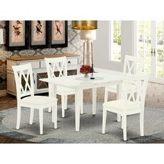 a white dining table and chairs in a room with rugs on the carpeted floor