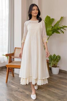 Buy off-white #chanderi #dress with smock pattern on yoke & yellow applique embroidered #floral motifs on sleeve at #AzaFashions Shop online now at #Azafashions.com Call +91 8291990059 or email contactus@azafashions.com for enquiries. #wedding #festive #ethnic #tradional #shopping #shoponline #party डिजाइनर कपड़े, Simple Frock Design, Simple Frocks, Simple Kurta Designs, Simple Kurti Designs, Frock For Women, Long Kurti Designs, Long Dress Design, Dress Design Patterns