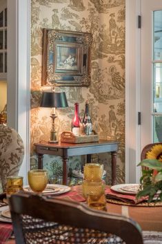 the dining room table is set with place settings for two people to sit and eat