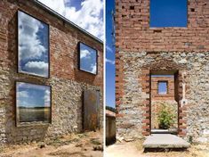 an old brick building with two windows and a stone bench