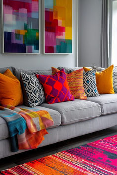 a living room filled with lots of colorful pillows and blankets on top of a gray couch