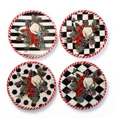 four black and white plates with roses on them, all decorated in red and white stripes