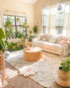 a living room filled with lots of plants and furniture