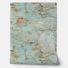 an old, peeling blue paint on the side of a wooden paneled wall or floor