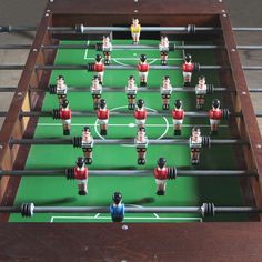 a foosball table with many small figurines on it's sides