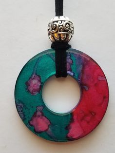 a necklace with a circular pendant hanging on a cord